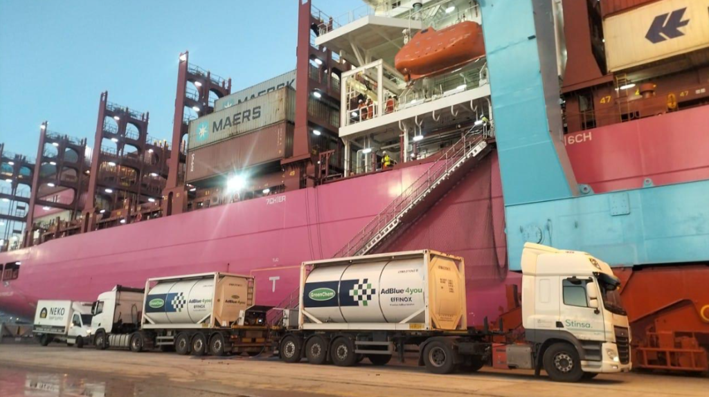 Container trucks and cargo ship at port